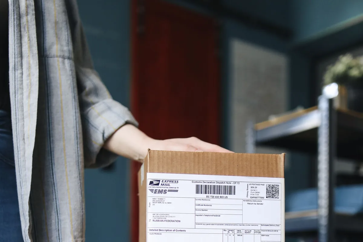 Palletized cardboard boxes stacked and shrink-wrapped in a warehouse, ready for delivery